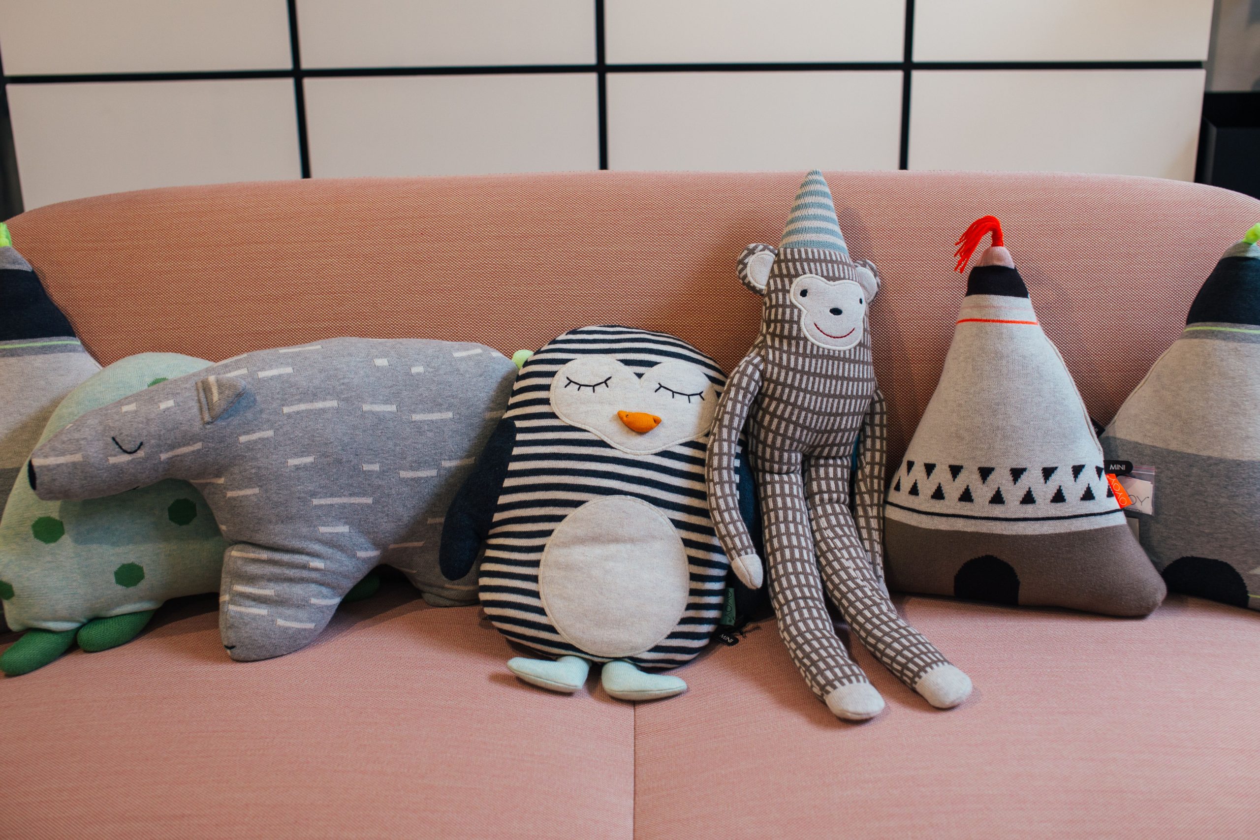 Rangée de jouets souples sur canapé moderne