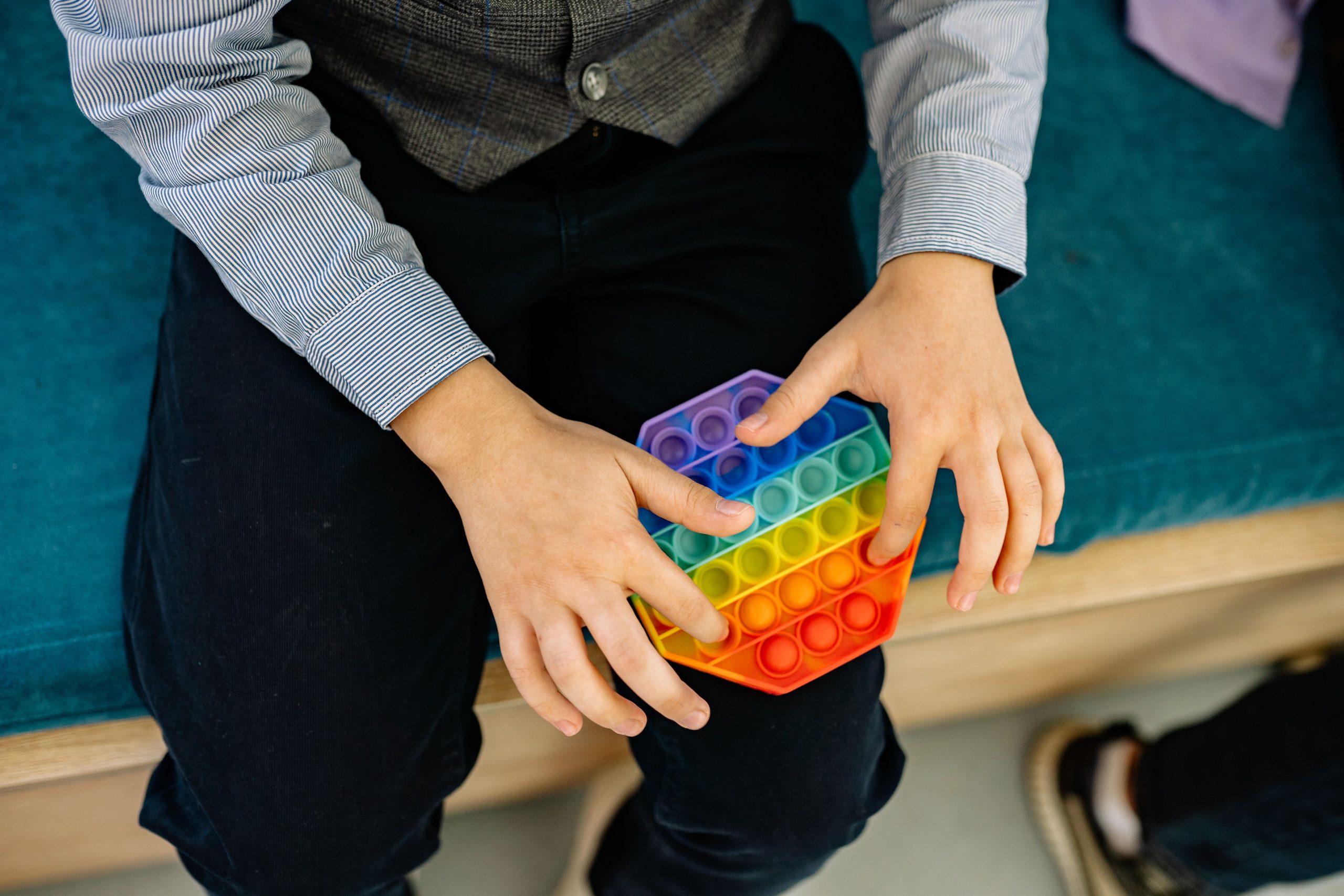 Enfant manipulant un pop it fidget sensoriel